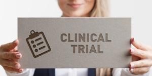 woman holding clinical trial sign